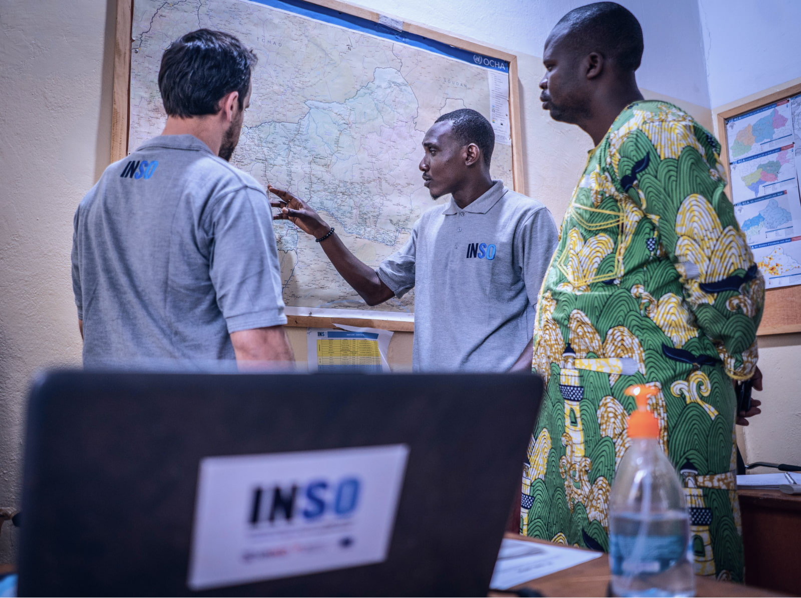 INSO staff members in Bangui, CAR discuss incidents using a map. Credit: C. Di Roma/INSO