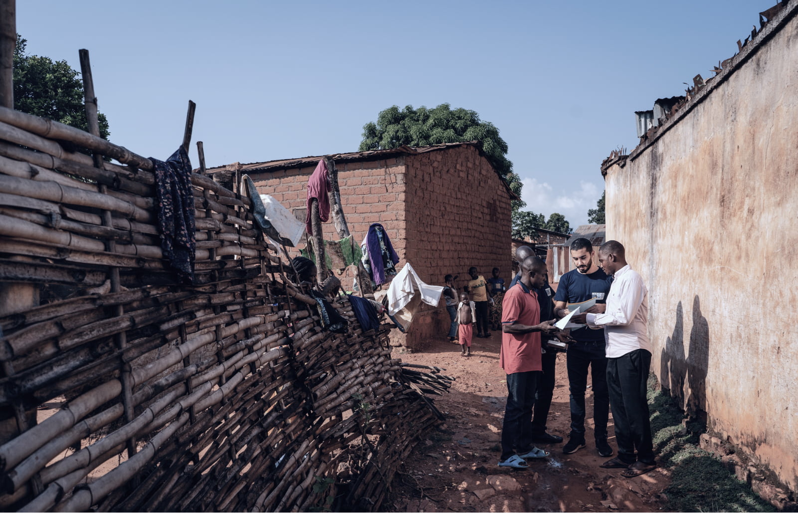 An INSO team discuss with a man who had his roof destroyed during fighting in January 2021﻿ in Bambari, CAR. Credit: C. Di Roma/INSO