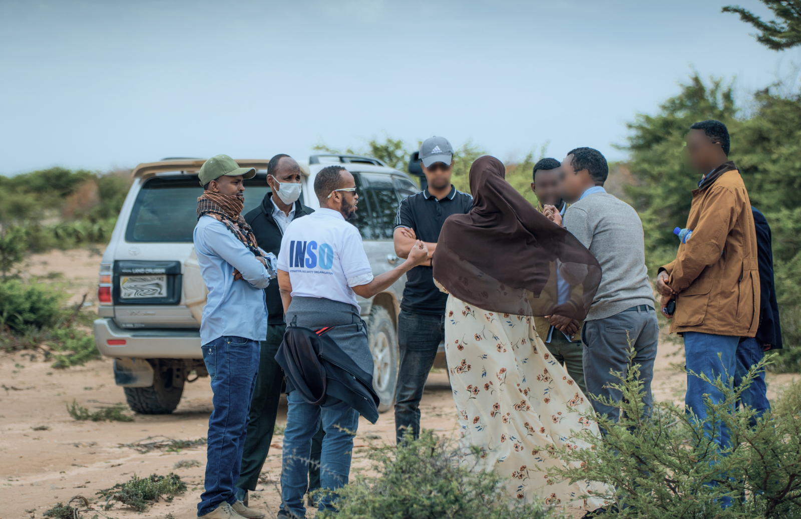 An INSO staff member talks to community next to the road in Somalia