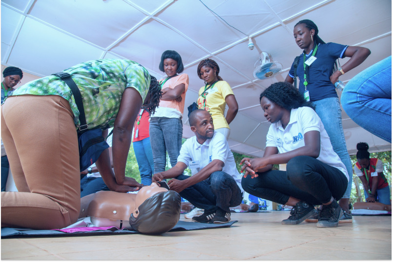 INSO training team supervise a CPR lesson as a participant practises